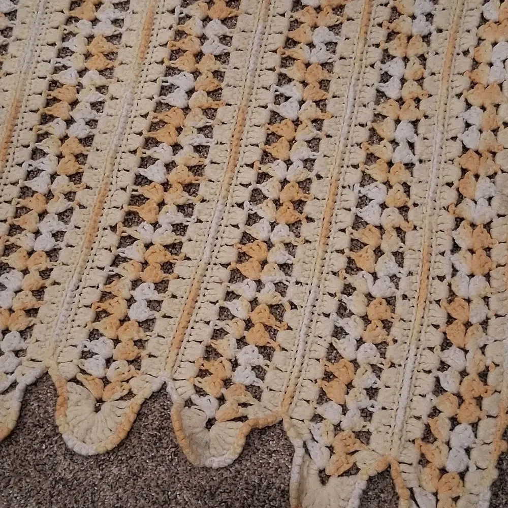 Handmade yellow and white crocheted baby‎ blanket with a scalloped edge
